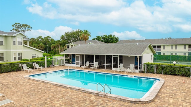 view of pool with a patio area and a sunroom