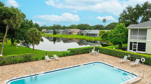 view of pool with a patio and a water view