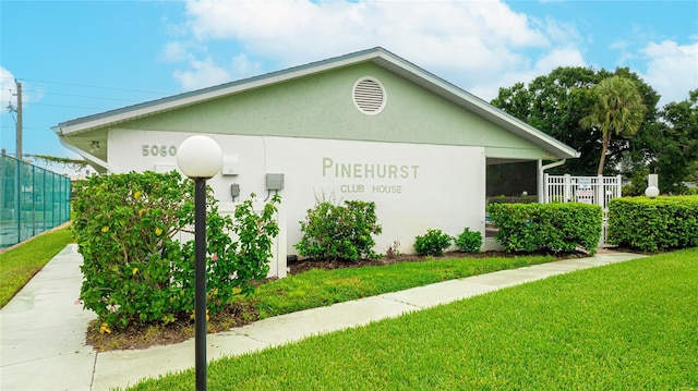 view of side of home featuring a lawn