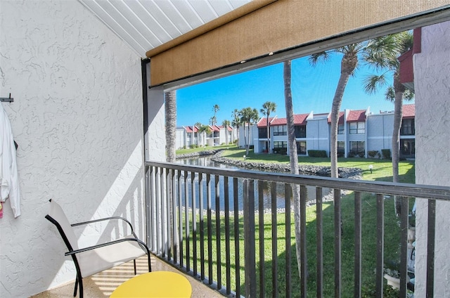 balcony featuring a water view and a residential view