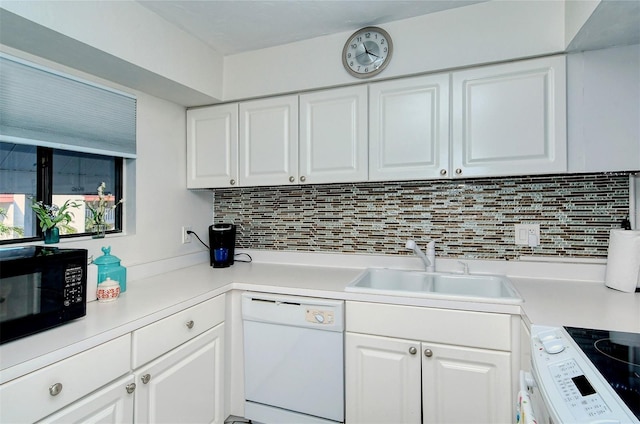 kitchen with white appliances, white cabinets, and light countertops