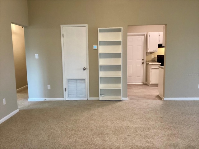 unfurnished bedroom featuring light carpet