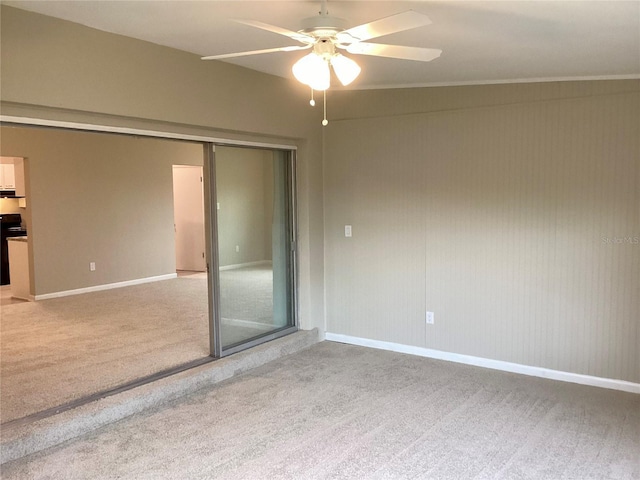 empty room with ceiling fan and light colored carpet