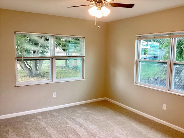 unfurnished room with ceiling fan and carpet