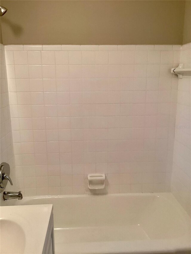 bathroom with vanity and washtub / shower combination