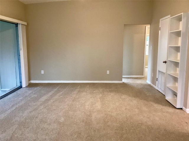 unfurnished bedroom featuring light carpet