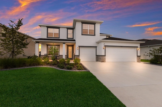 view of front of house featuring a garage and a lawn