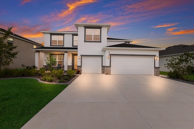 view of front facade with a garage and a yard