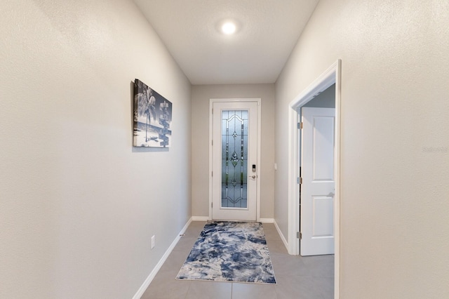 doorway featuring light tile patterned flooring