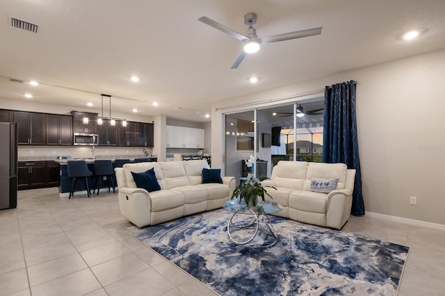 living room with light tile patterned floors and ceiling fan