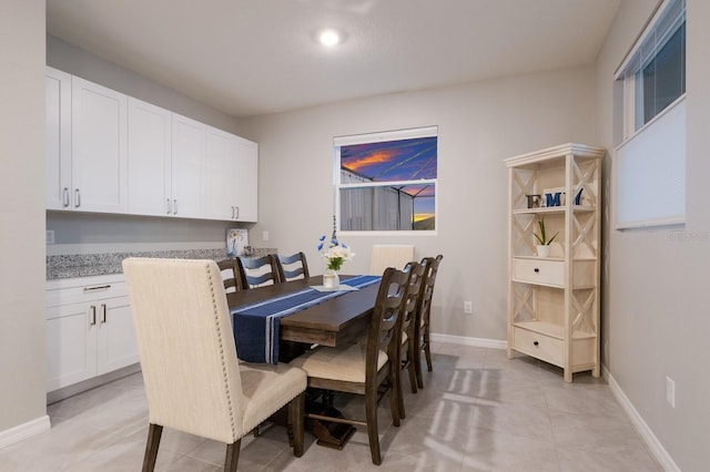 dining space featuring light tile patterned floors