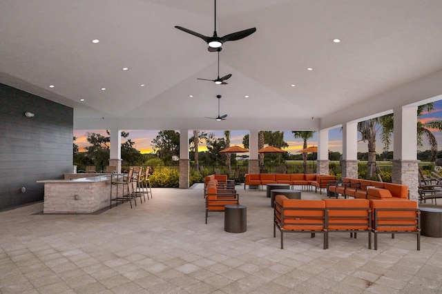 patio terrace at dusk with an outdoor living space and ceiling fan