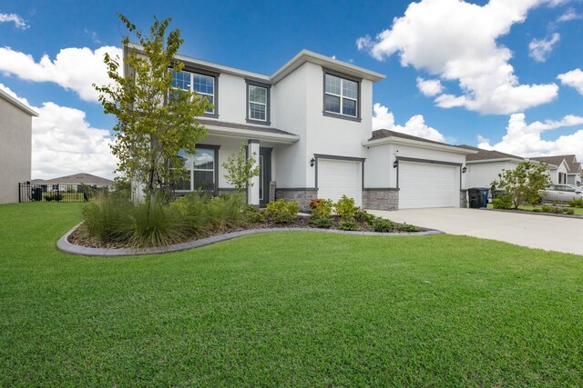 view of front of home with a garage and a front lawn