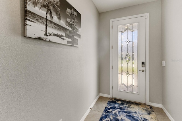 doorway to outside with tile patterned flooring