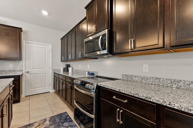 kitchen featuring stainless steel appliances and dark brown cabinetry