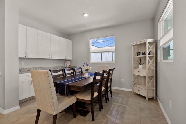 dining space with light tile patterned floors and a wealth of natural light