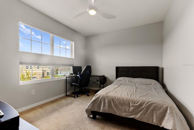 bedroom featuring ceiling fan and light carpet