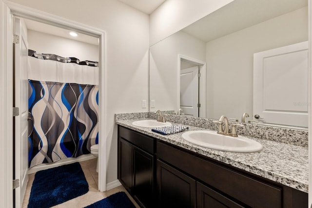 bathroom featuring vanity, tile patterned floors, and toilet