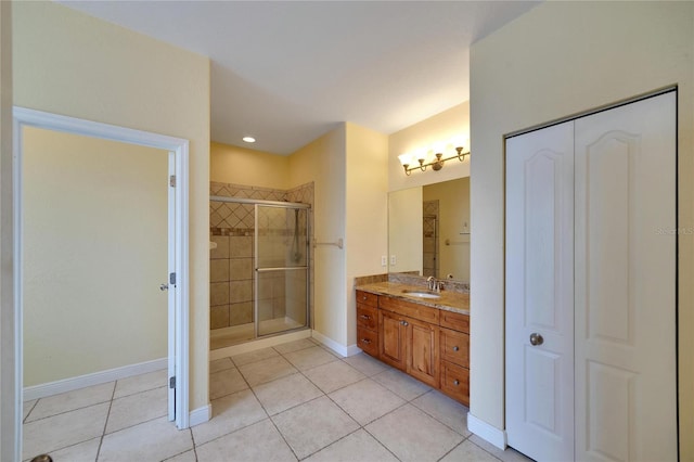 bathroom with tile patterned flooring, vanity, and an enclosed shower