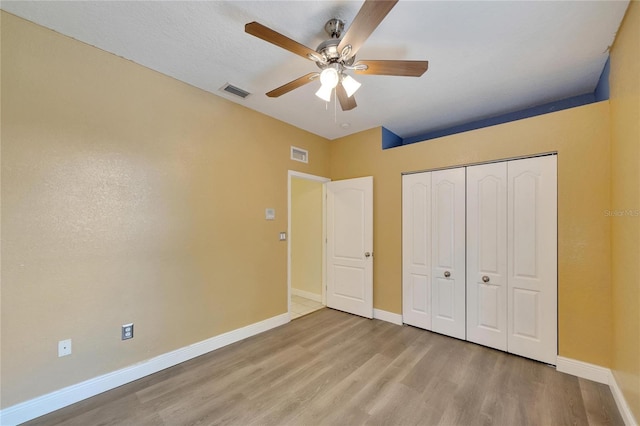 unfurnished bedroom with a closet, ceiling fan, and light hardwood / wood-style floors