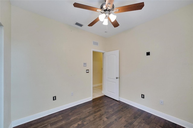 spare room featuring ceiling fan and dark hardwood / wood-style floors