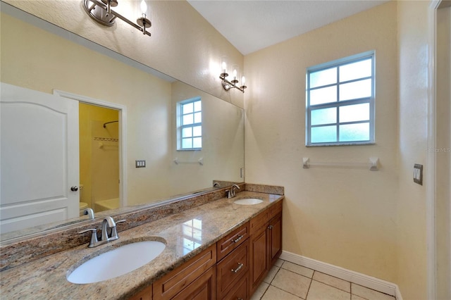 bathroom with tile patterned flooring, vanity, and toilet