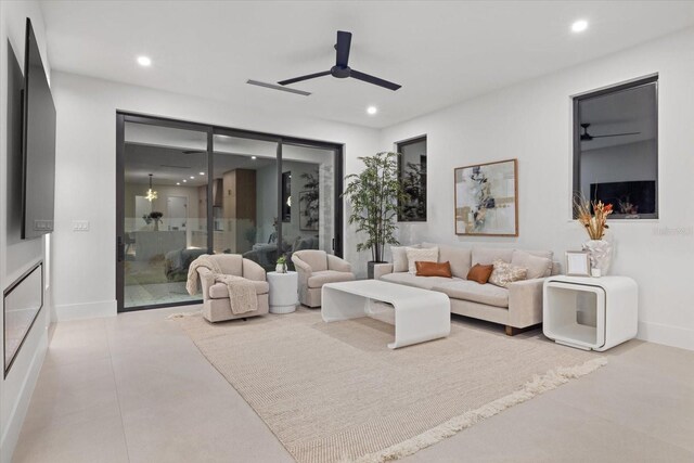 living room with ceiling fan, baseboards, and recessed lighting