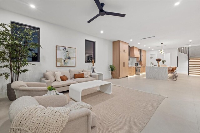 living room featuring recessed lighting, ceiling fan, and stairs