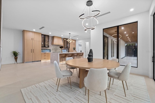 dining room with a chandelier, recessed lighting, and visible vents