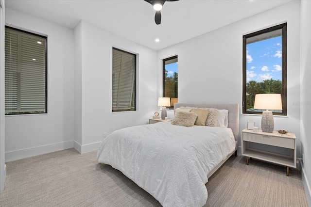 bedroom with light carpet, recessed lighting, a ceiling fan, and baseboards