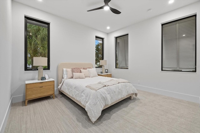 bedroom with recessed lighting, baseboards, a ceiling fan, and light colored carpet