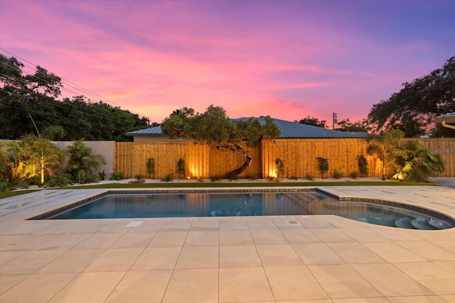 view of swimming pool featuring a patio, a fenced backyard, and a fenced in pool