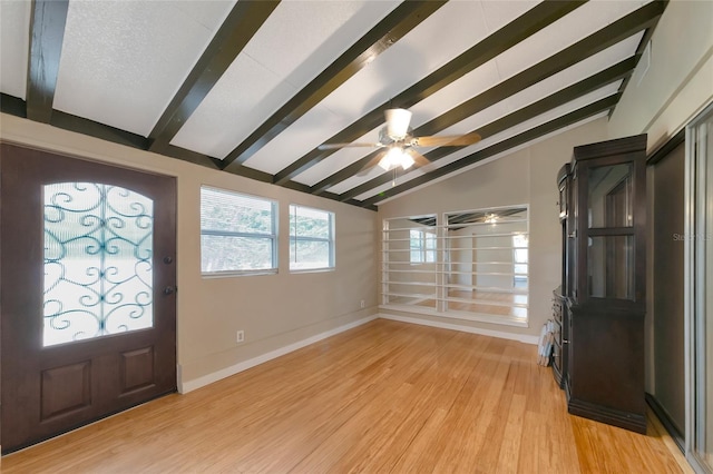 foyer featuring light wood-type flooring, ceiling fan, and vaulted ceiling with beams