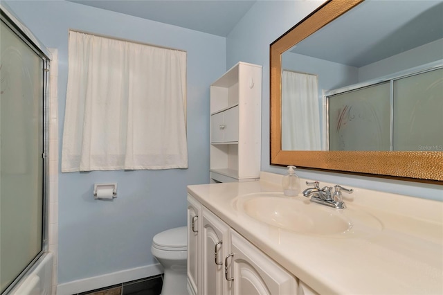 full bathroom featuring toilet, vanity, tile patterned floors, and shower / bath combination with glass door