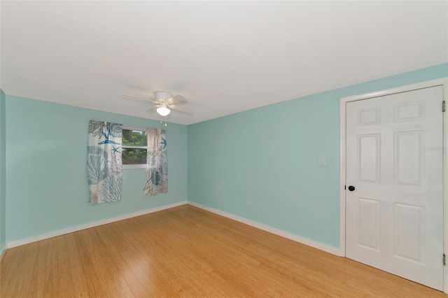 empty room with ceiling fan and light wood-type flooring