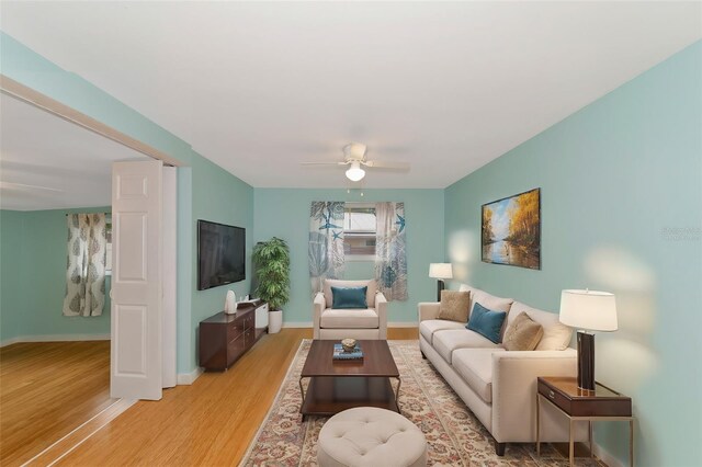 living room featuring ceiling fan and light hardwood / wood-style floors