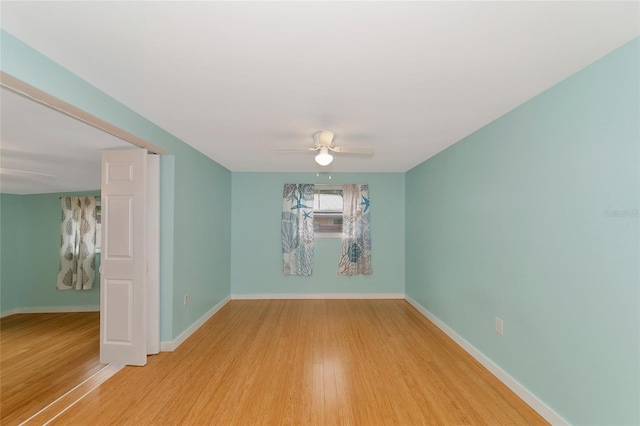 spare room with ceiling fan and hardwood / wood-style flooring