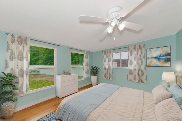 bedroom with ceiling fan and light hardwood / wood-style flooring