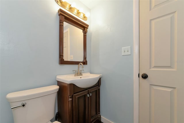 bathroom featuring toilet and vanity