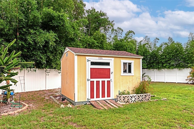 view of outbuilding featuring a lawn