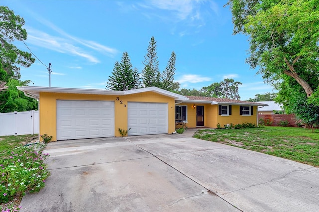 ranch-style home with a front lawn and a garage