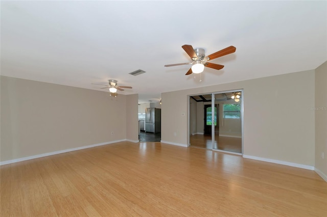 unfurnished room featuring ceiling fan and light hardwood / wood-style floors