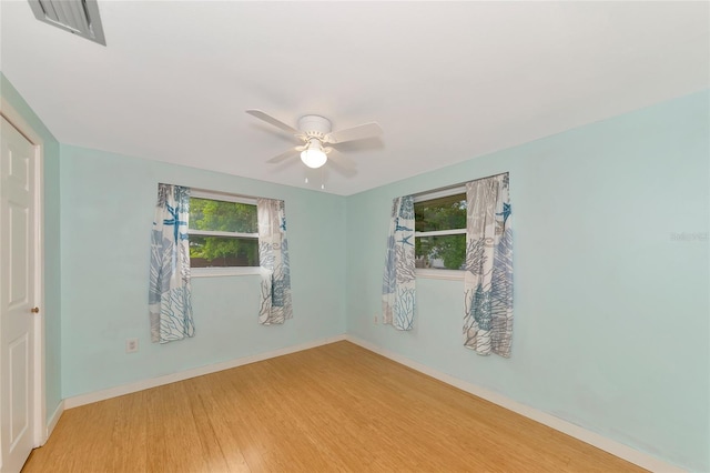 empty room with light wood-type flooring and ceiling fan