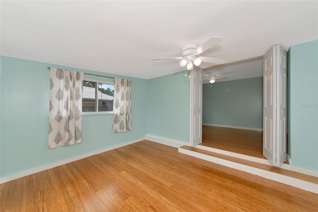 spare room with ceiling fan and light hardwood / wood-style flooring