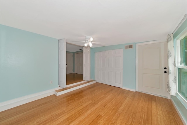 unfurnished bedroom with ceiling fan and light wood-type flooring