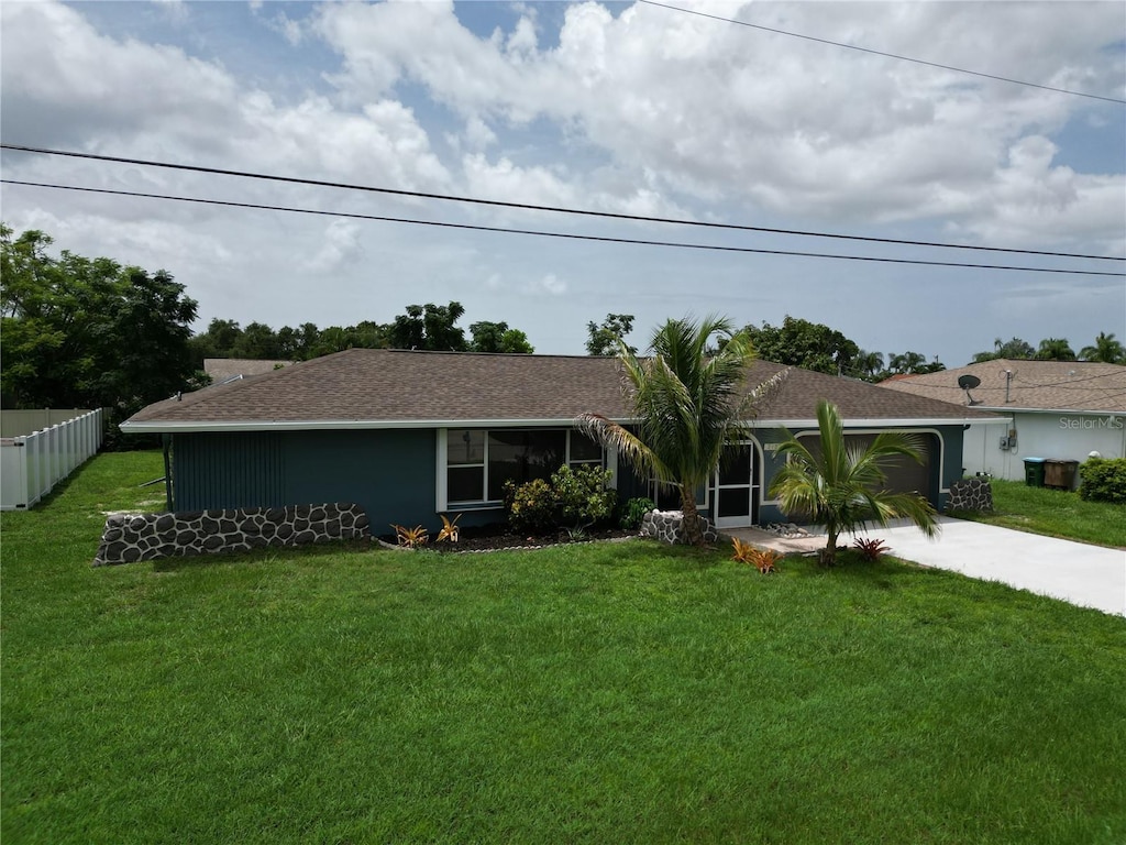 ranch-style home featuring a garage and a front yard