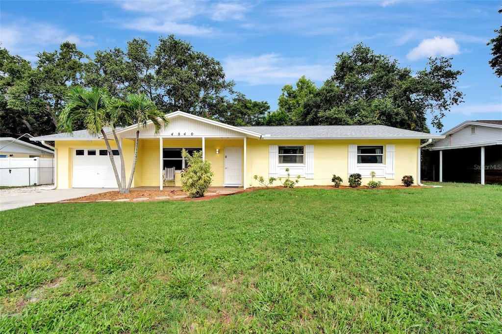 ranch-style home featuring a garage and a front yard