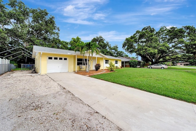 ranch-style home with a front yard and a garage