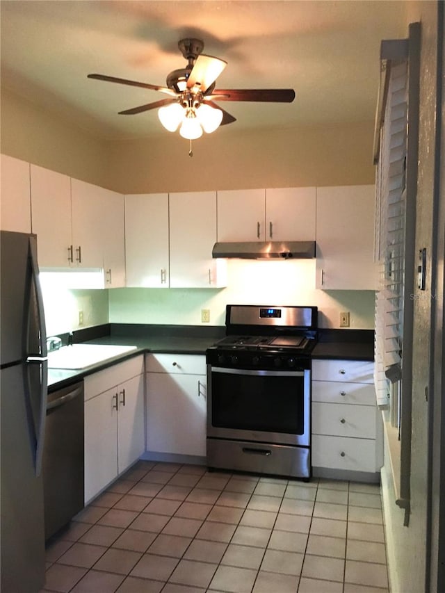 kitchen with ceiling fan, white cabinets, sink, appliances with stainless steel finishes, and light tile patterned floors