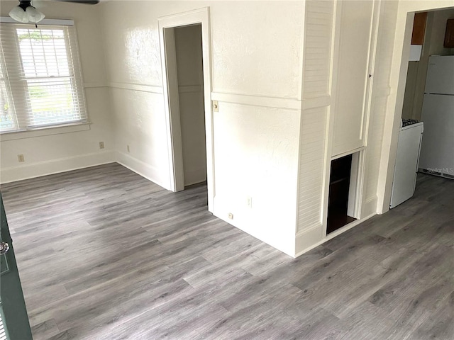 empty room with ceiling fan and hardwood / wood-style floors